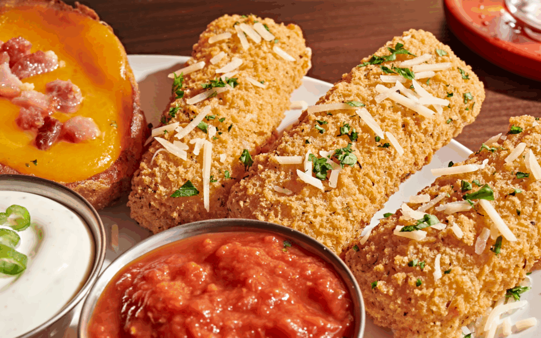 Close-up of mozzarella sticks and loaded potato skins at TGI Fridays, featuring craveable late night bar food perfect for sharing after 9 PM.