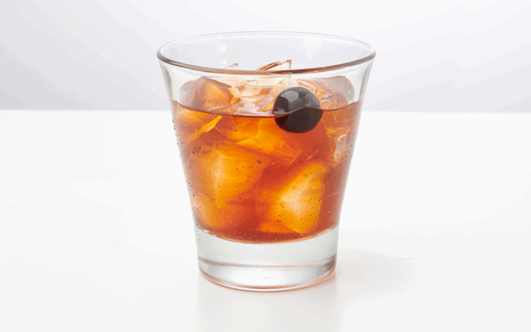 Bourbon cocktail with cherry garnish on ice, inspired by TGI Fridays Old Fashioned