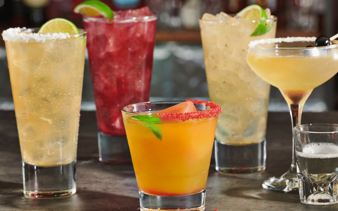 A lineup of non-alcoholic margaritas made with spiritless tequila, featuring citrus garnishes and salted rims at TGI Fridays.