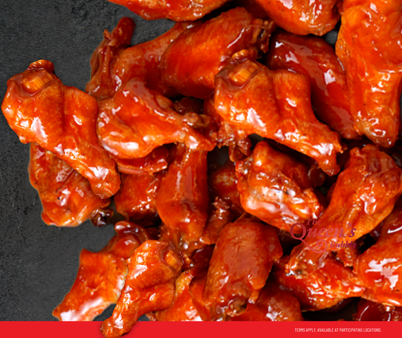Close-up of traditional buffalo chicken wings coated in signature sauce at TGI Fridays.